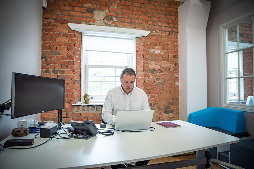 Owner of business at desk with laptop